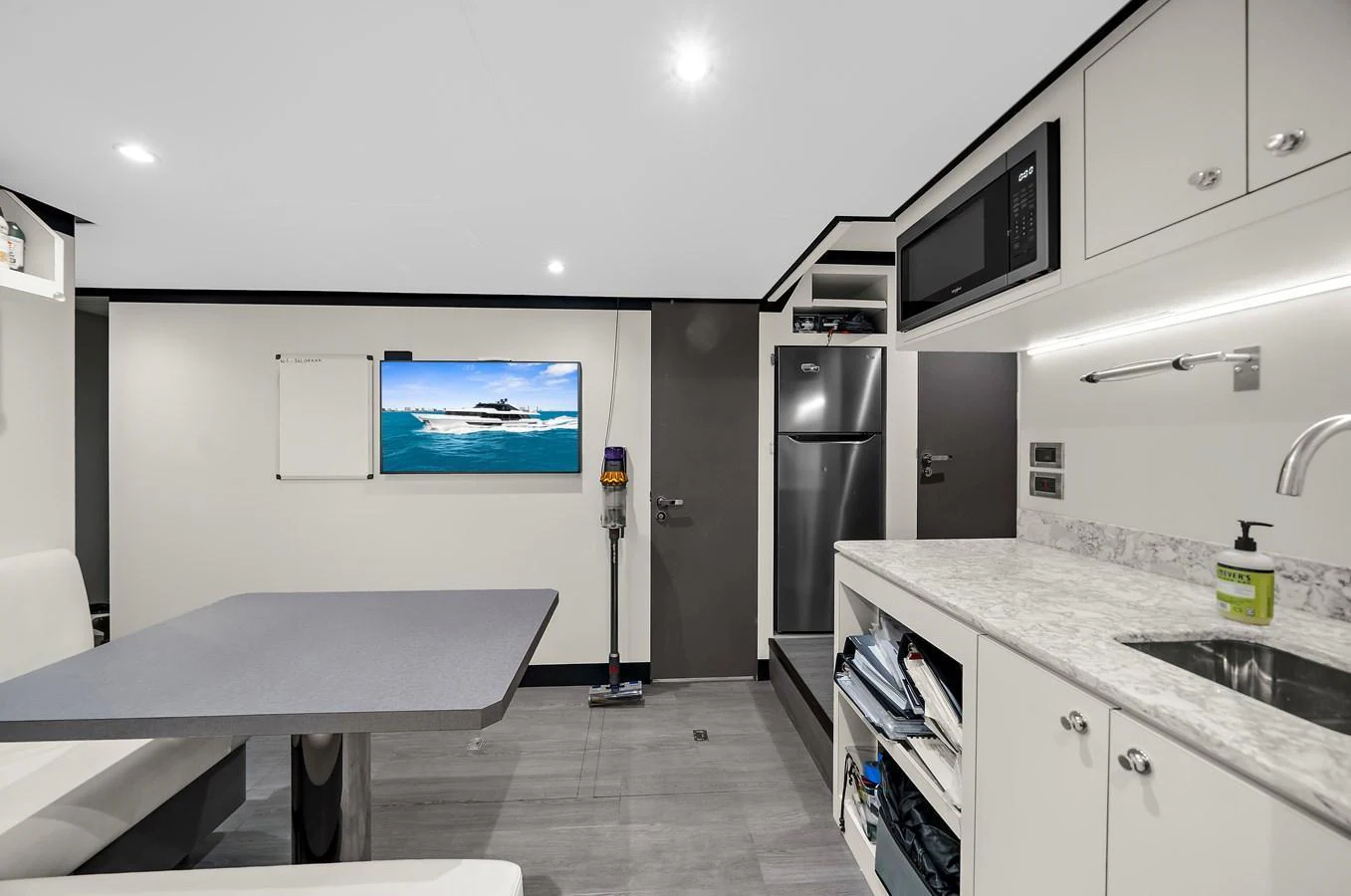 The galley features modern appliances and a sleek dining area, perfect for onboard meals. aboard LA LA LA Yacht for Sale