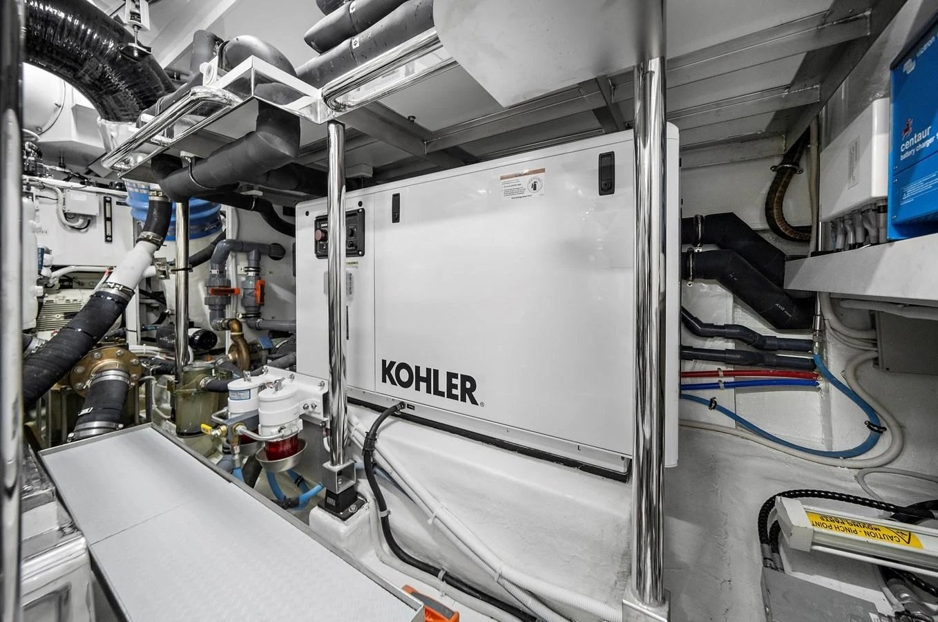 The image showcases the well-organized engine room with visible machinery and equipment. aboard LA LA LA Yacht for Sale