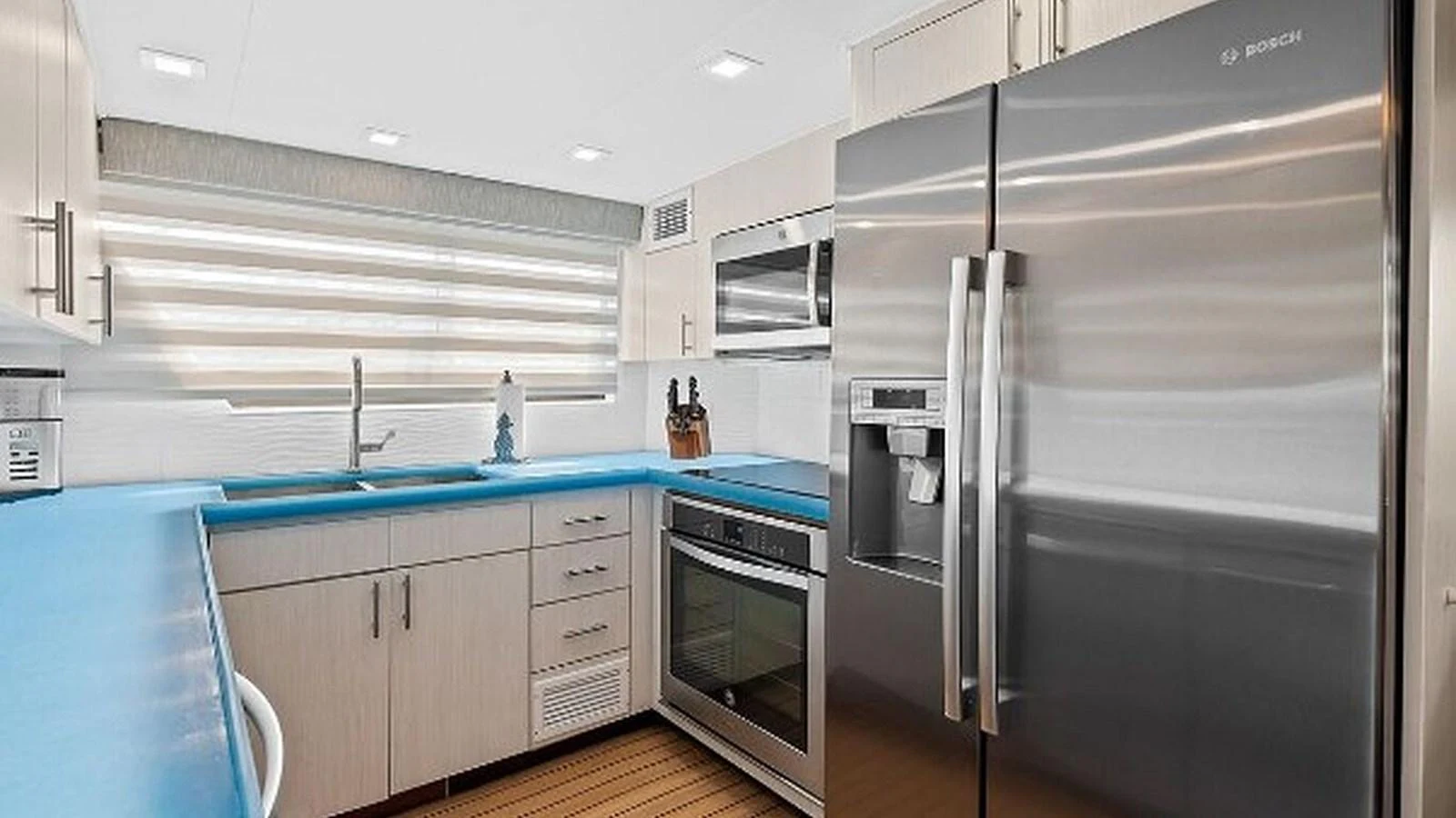 The modern galley features sleek stainless steel appliances and ample counter space. aboard TOP GUN Yacht for Sale