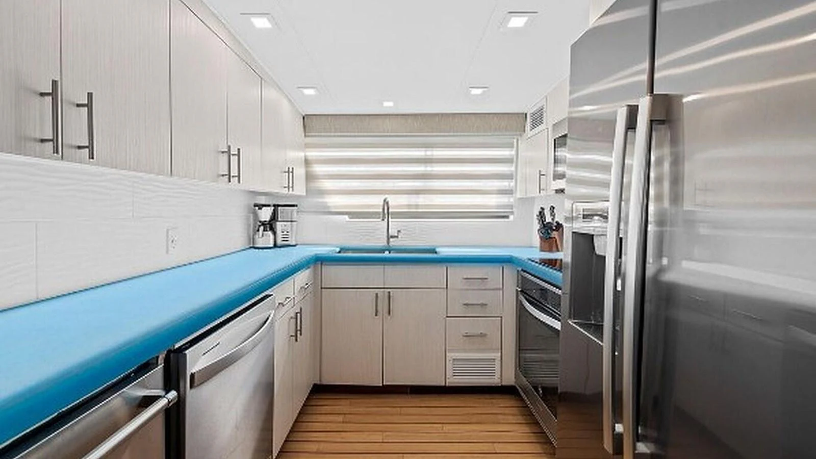 The modern galley features sleek stainless steel appliances and ample counter space for gourmet meal preparation. aboard TOP GUN Yacht for Sale