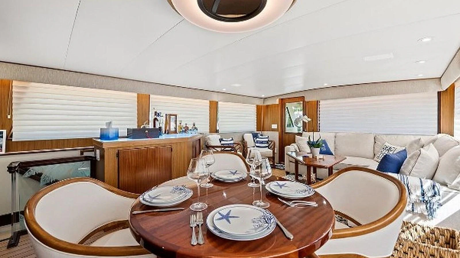 The yacht's salon features a stylish dining area with elegant table settings and comfortable seating. aboard TOP GUN Yacht for Sale