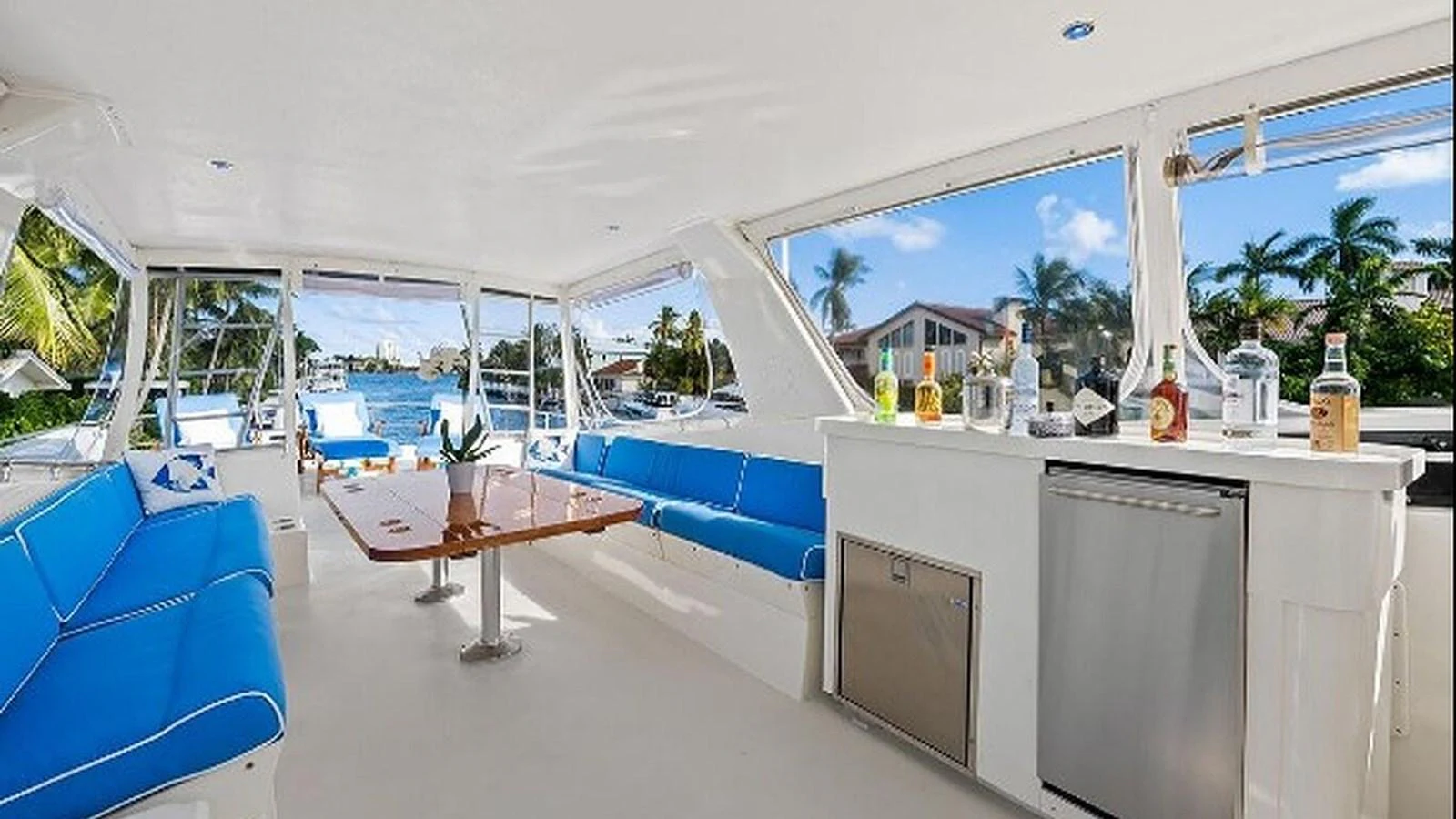 The saloon offers a spacious and bright area with comfortable seating and a well-equipped bar, perfect for relaxation and entertainment. aboard TOP GUN Yacht for Sale