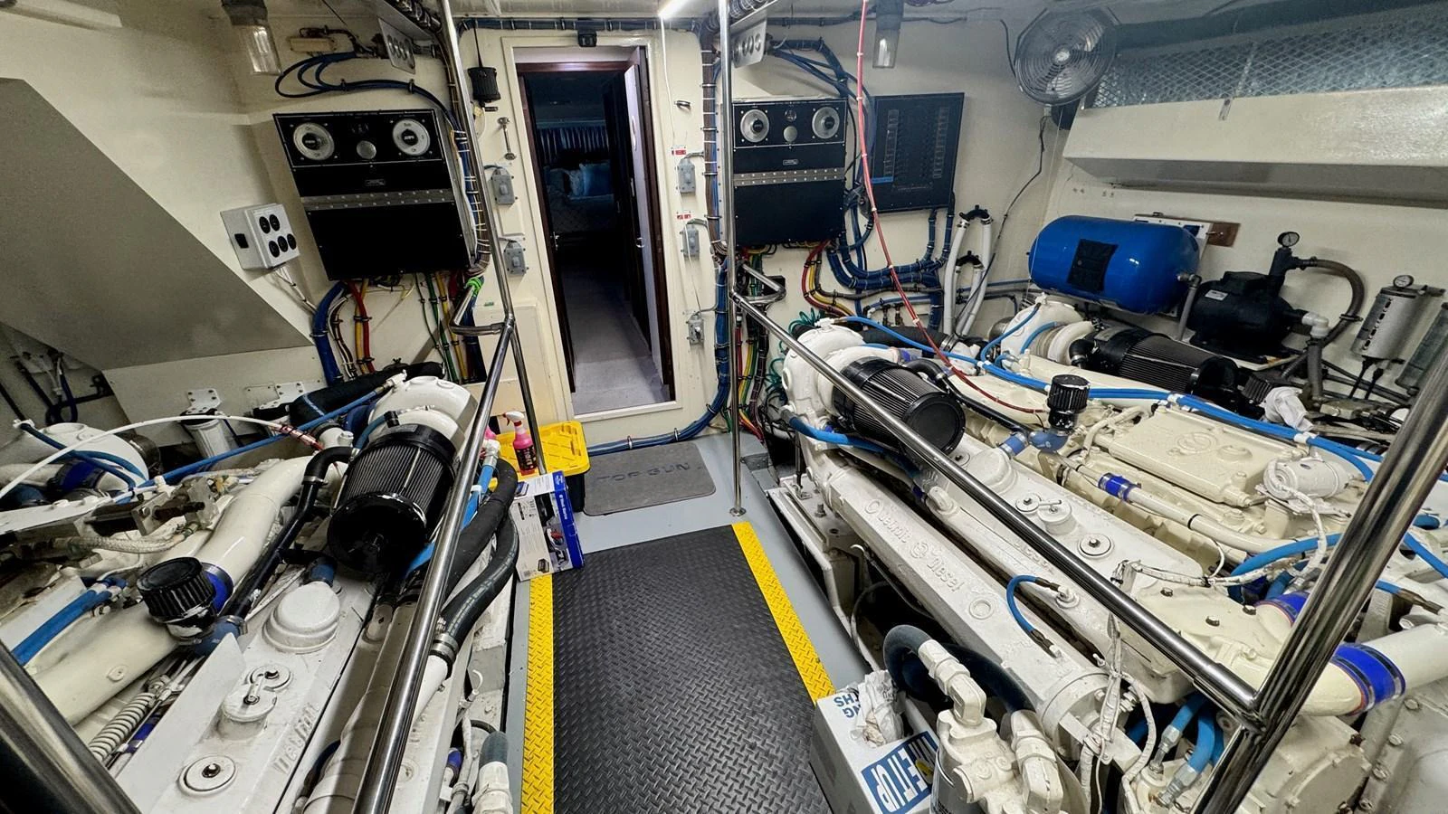 The image showcases the well-maintained engine room of the yacht, highlighting its advanced mechanical systems. aboard TOP GUN Yacht for Sale