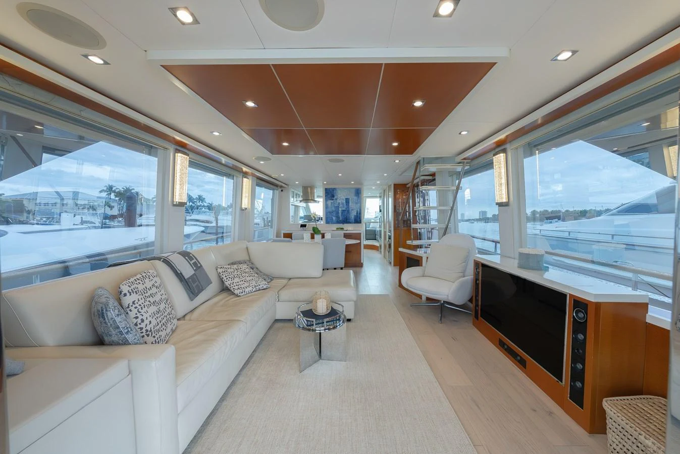 The spacious salon features a comfortable seating area with large windows offering panoramic views. aboard WHISTLE Yacht for Sale