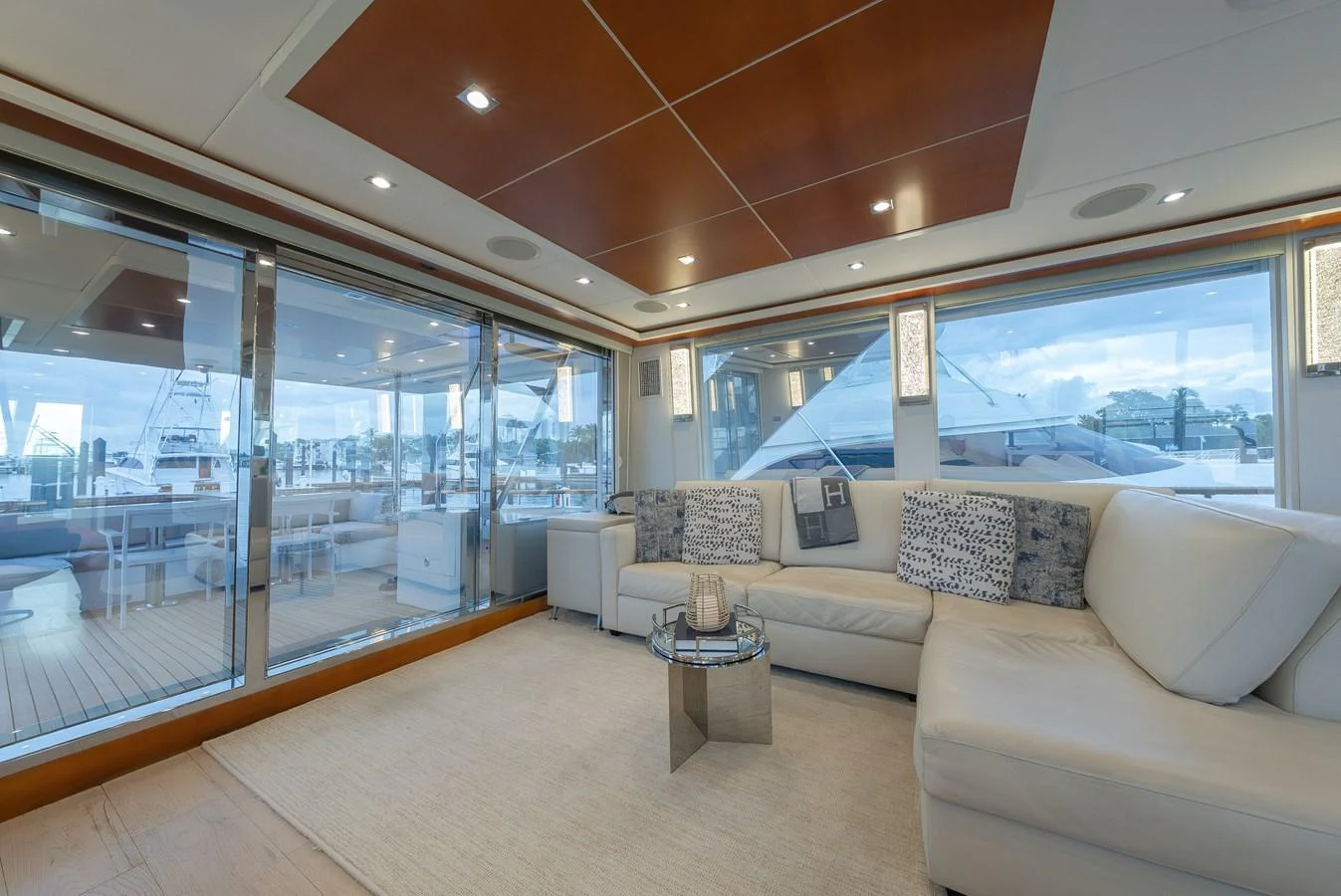 The salon offers a spacious and luxurious seating area with expansive views through large windows. aboard WHISTLE Yacht for Sale