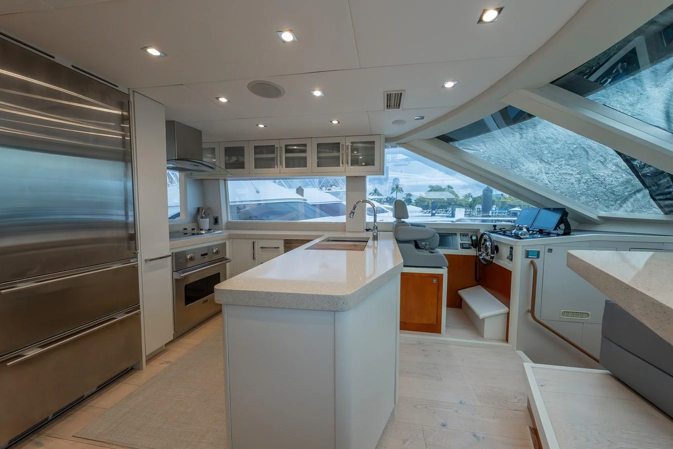 The yacht's galley features modern appliances and ample counter space with large windows providing natural light. aboard WHISTLE Yacht for Sale