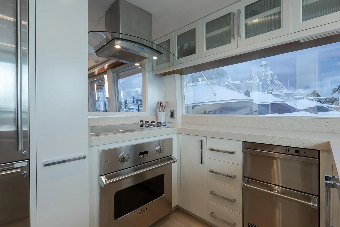 The modern galley features sleek stainless steel appliances and ample counter space with a view of the marina. aboard WHISTLE Yacht for Sale