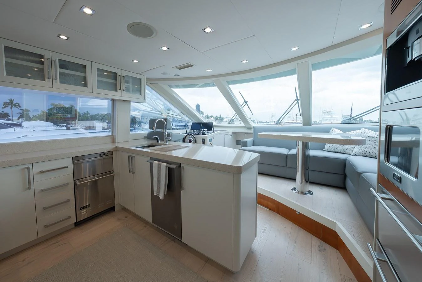 The yacht's galley features modern appliances and a spacious seating area with panoramic windows. aboard WHISTLE Yacht for Sale