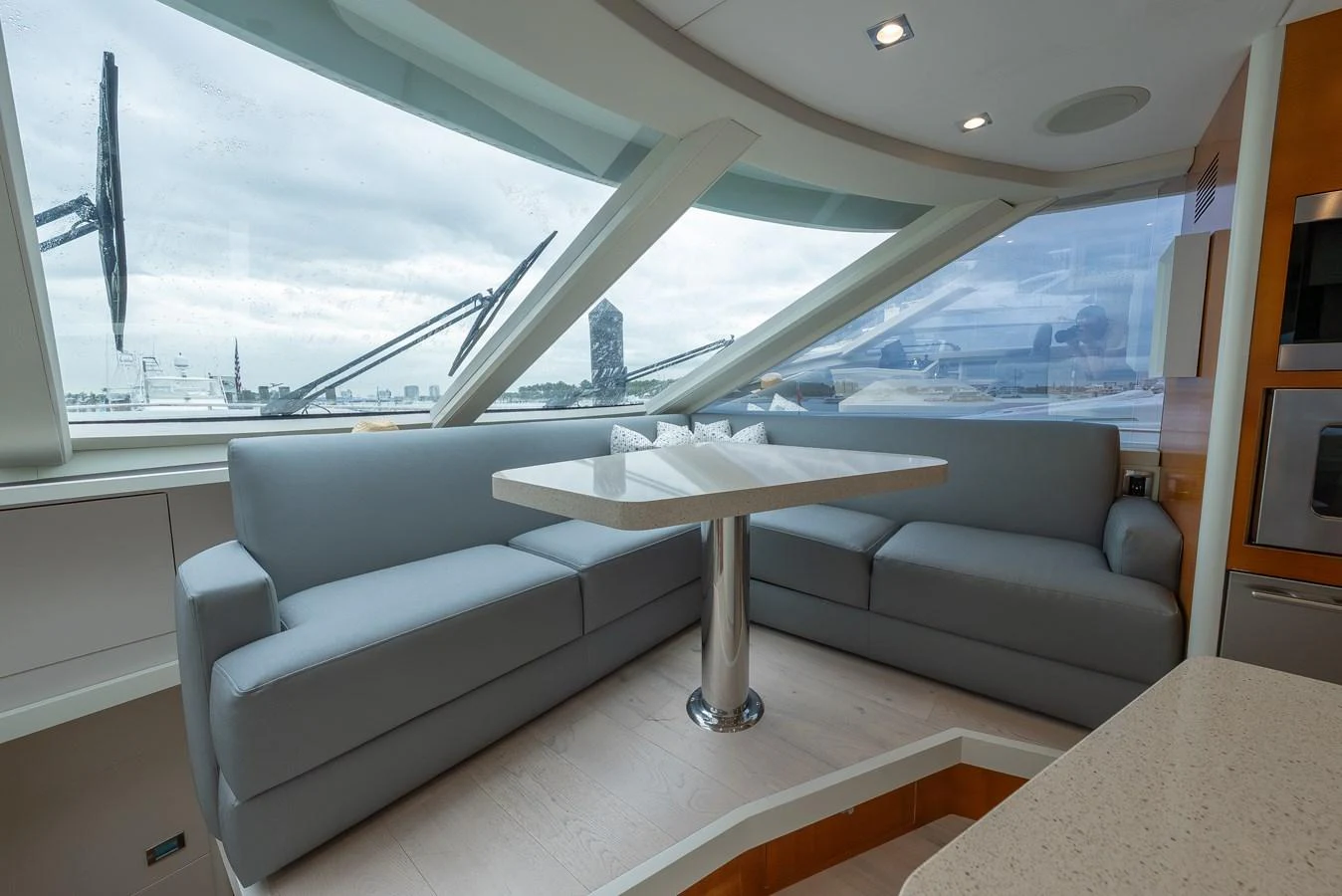 The yacht's interior features a cozy seating area with large windows offering panoramic views. aboard WHISTLE Yacht for Sale