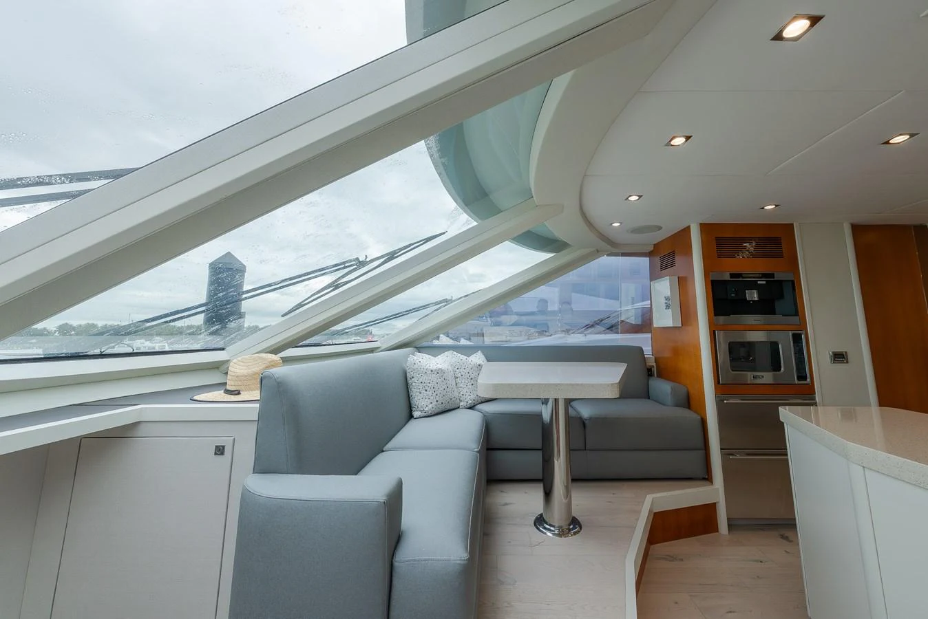 The salon features modern seating with panoramic windows offering stunning views. aboard WHISTLE Yacht for Sale