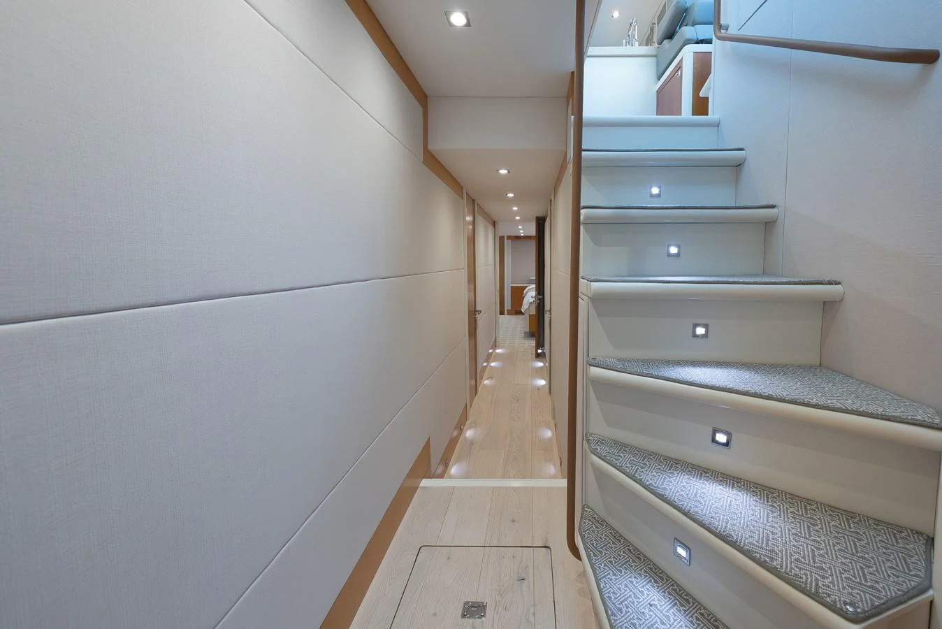 A sleek and modern hallway with illuminated steps leading to the lower deck. aboard WHISTLE Yacht for Sale