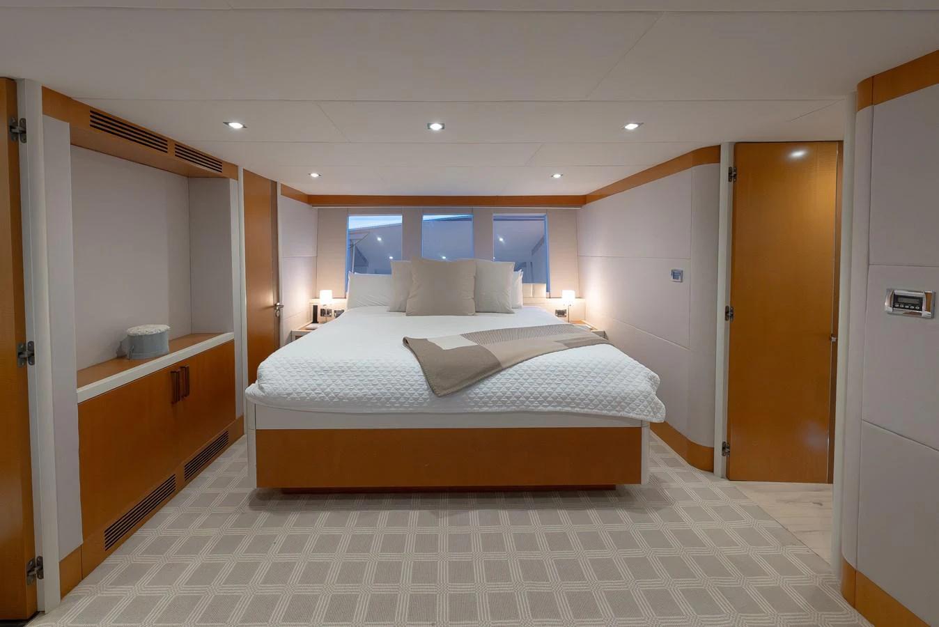 The master stateroom features a spacious bed with elegant wood accents and ample natural light. aboard WHISTLE Yacht for Sale