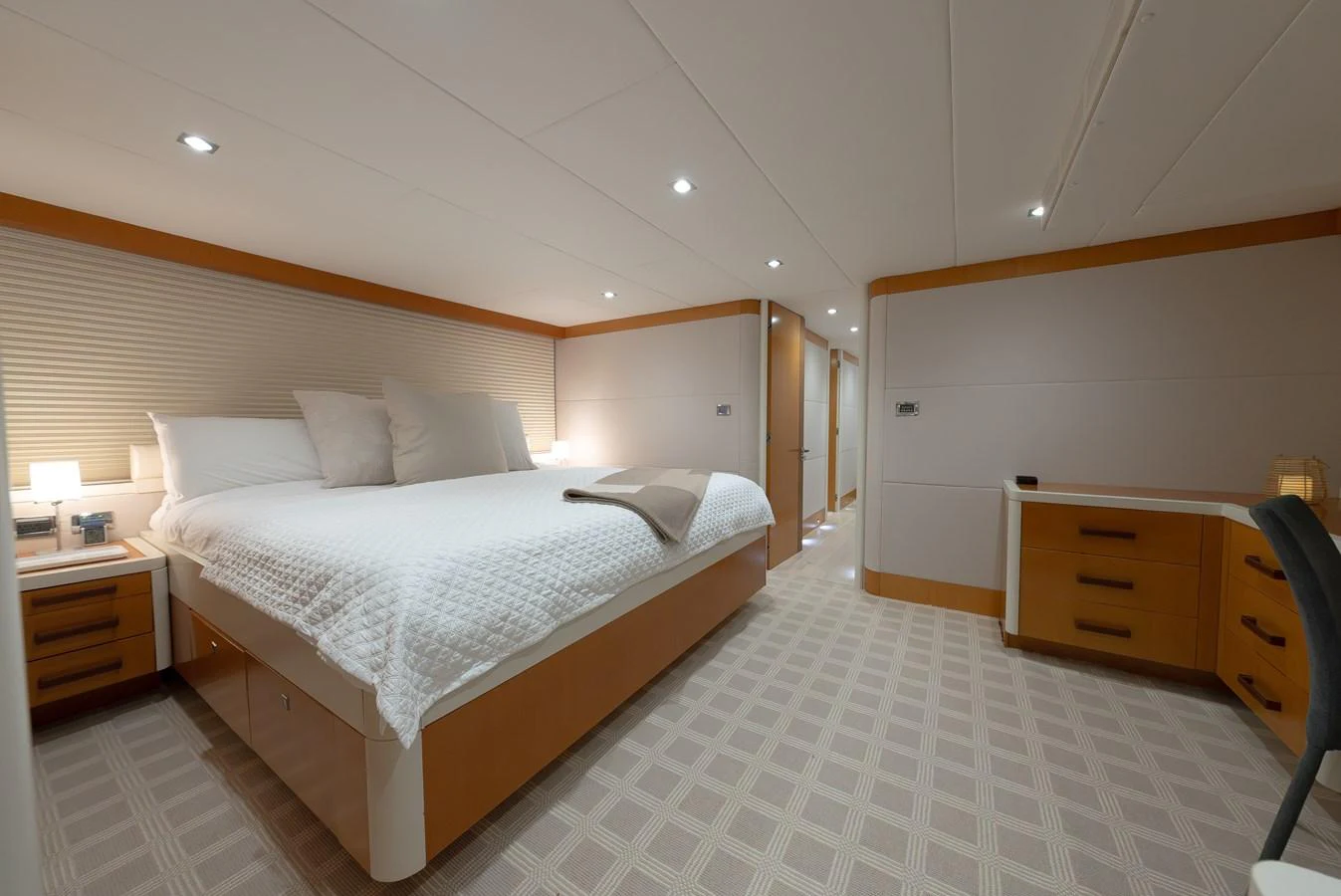 The stateroom features a spacious bed, ample lighting, and a modern design. aboard WHISTLE Yacht for Sale