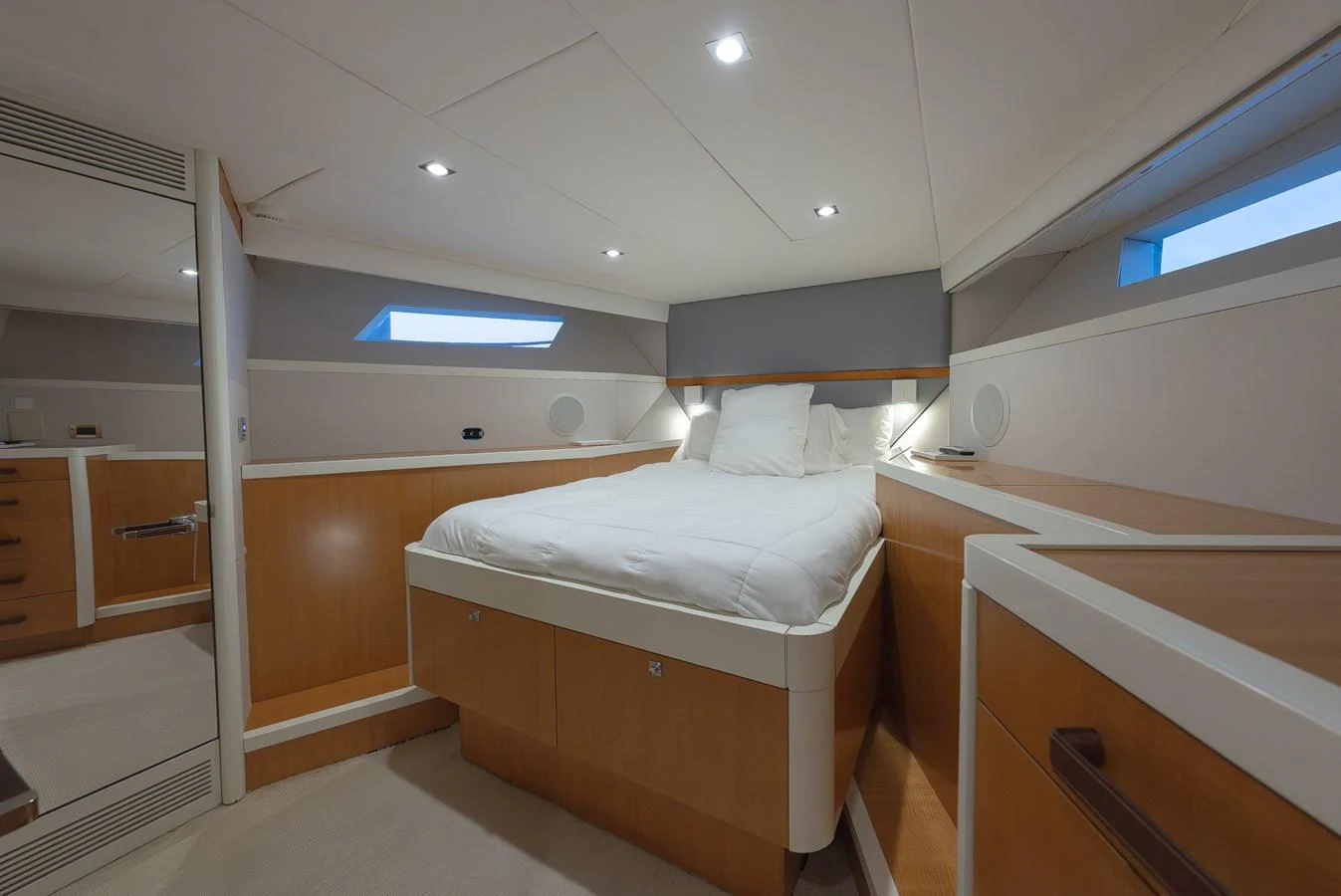 A cozy stateroom with a comfortable bed and modern lighting. aboard WHISTLE Yacht for Sale