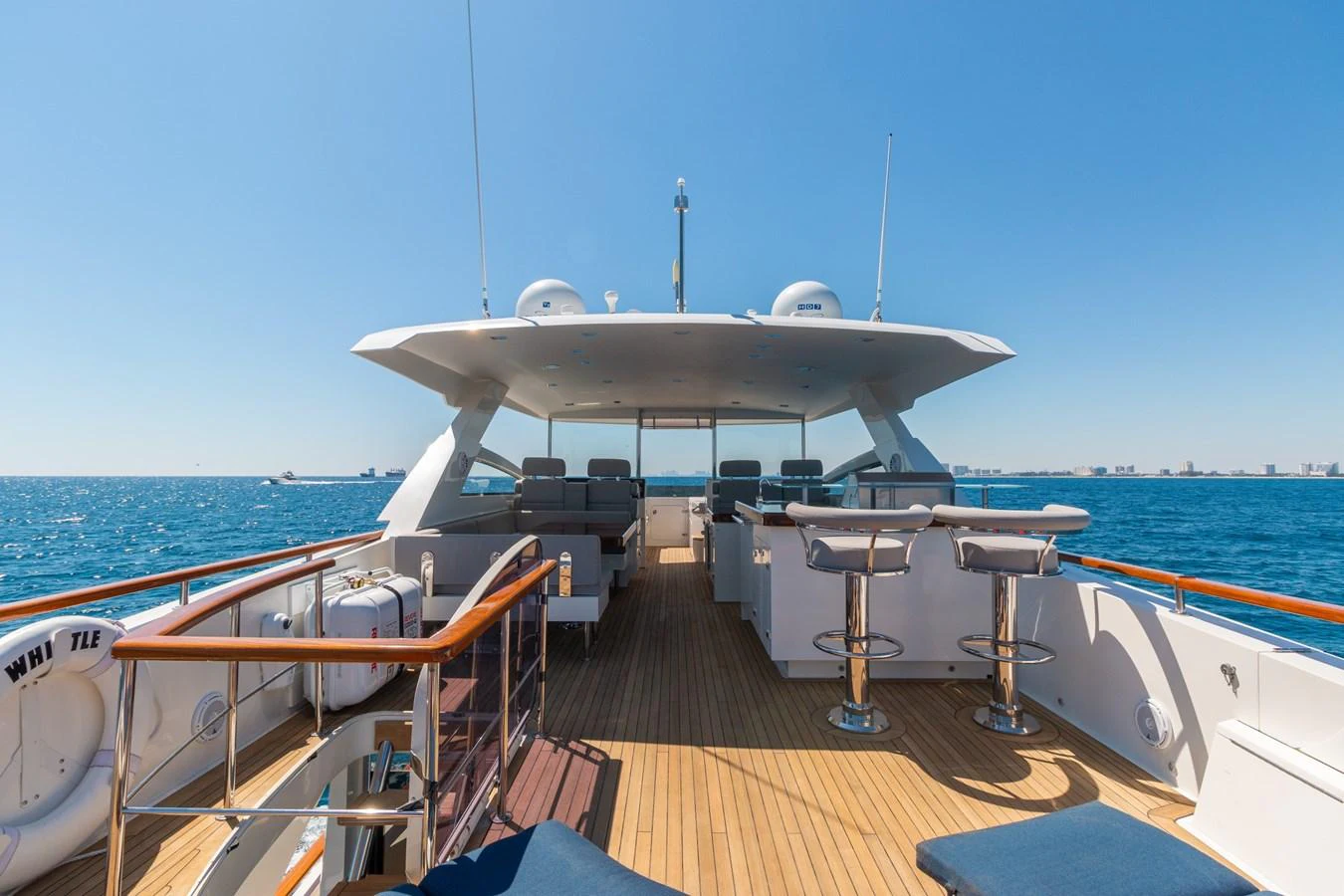The aft deck offers a spacious and inviting area for relaxation and socializing with stunning ocean views. aboard WHISTLE Yacht for Sale