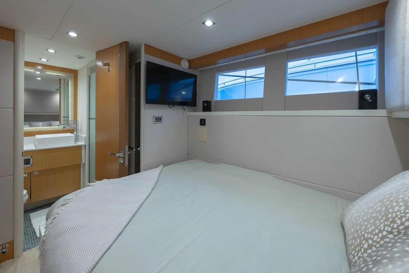 A cozy stateroom featuring a comfortable bed, modern fixtures, and ample natural light. aboard WHISTLE Yacht for Sale