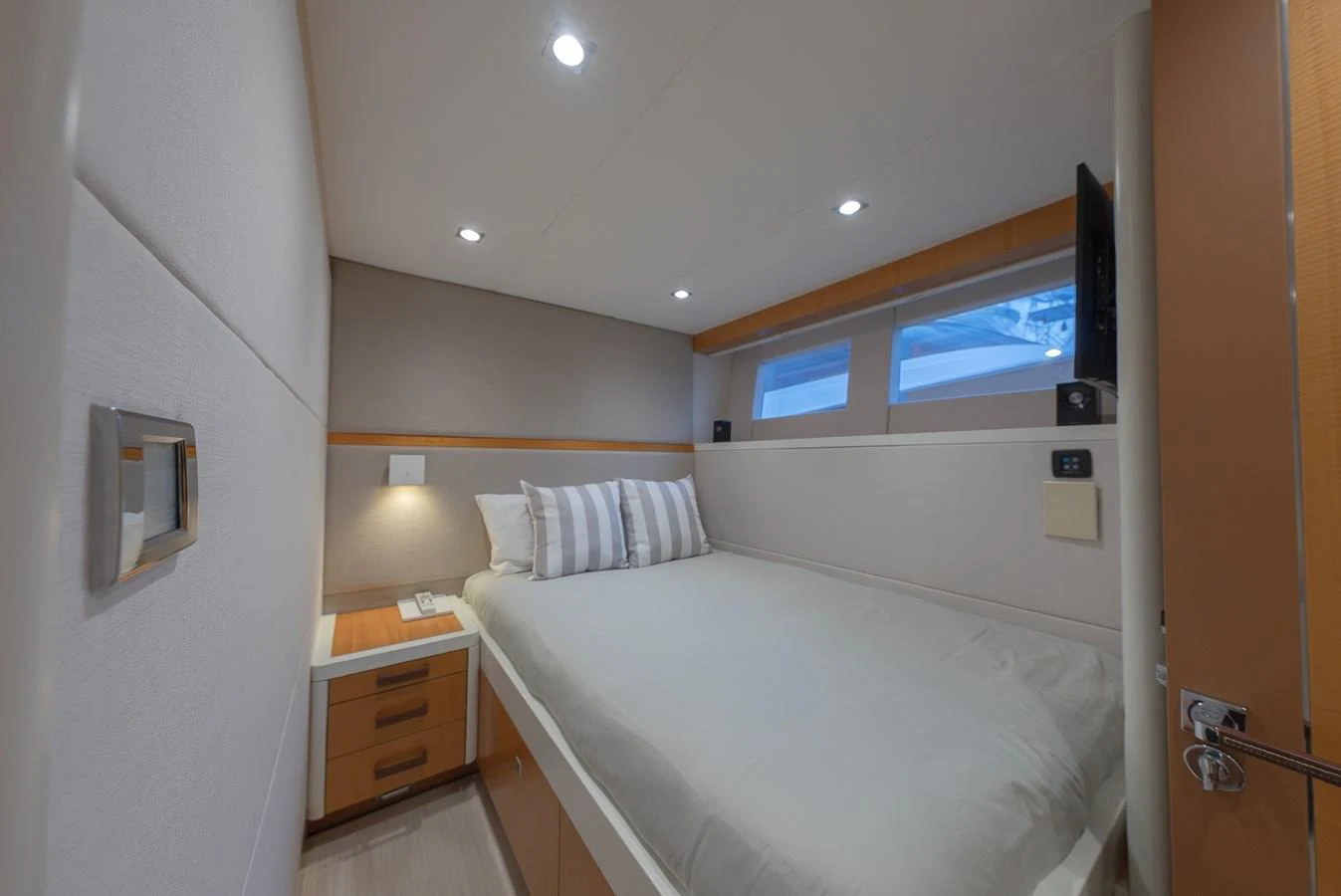 The guest stateroom features a cozy bed with modern furnishings and ample natural light. aboard WHISTLE Yacht for Sale