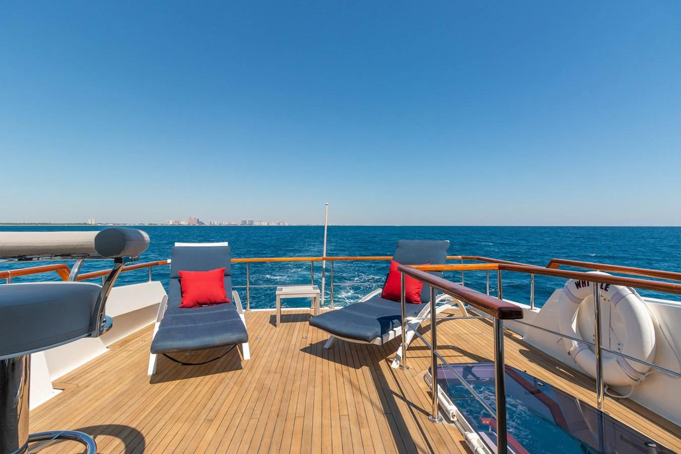 The aft deck offers a spacious and inviting area with sun loungers and a stunning ocean view. aboard WHISTLE Yacht for Sale