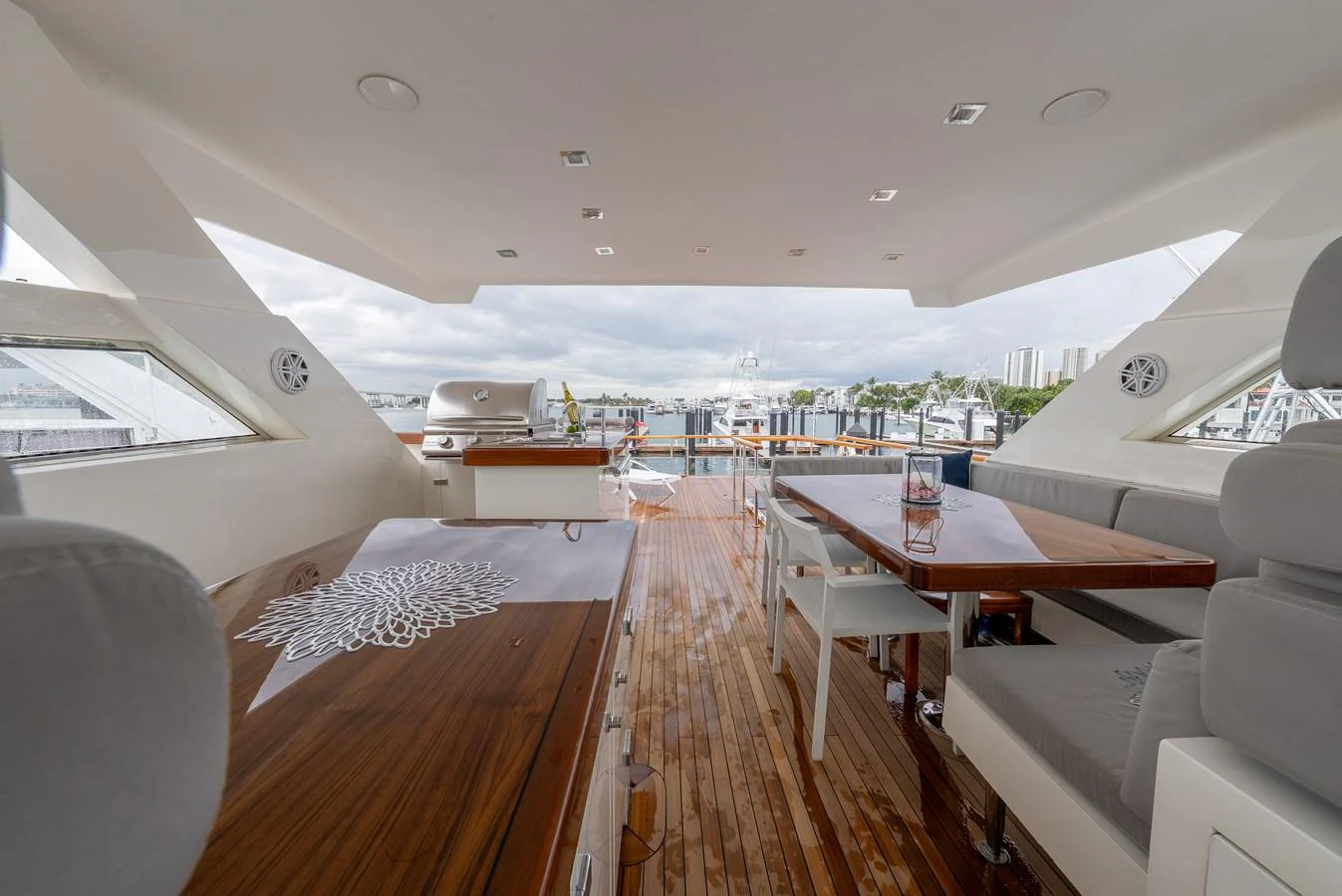 The flybridge offers a spacious and elegant area for relaxation and dining with a view of the marina. aboard WHISTLE Yacht for Sale