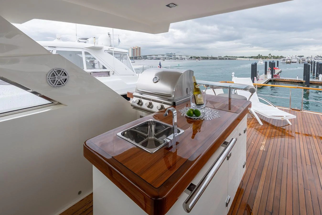 The aft deck features a sleek outdoor kitchen with a grill and sink, perfect for alfresco dining. aboard WHISTLE Yacht for Sale