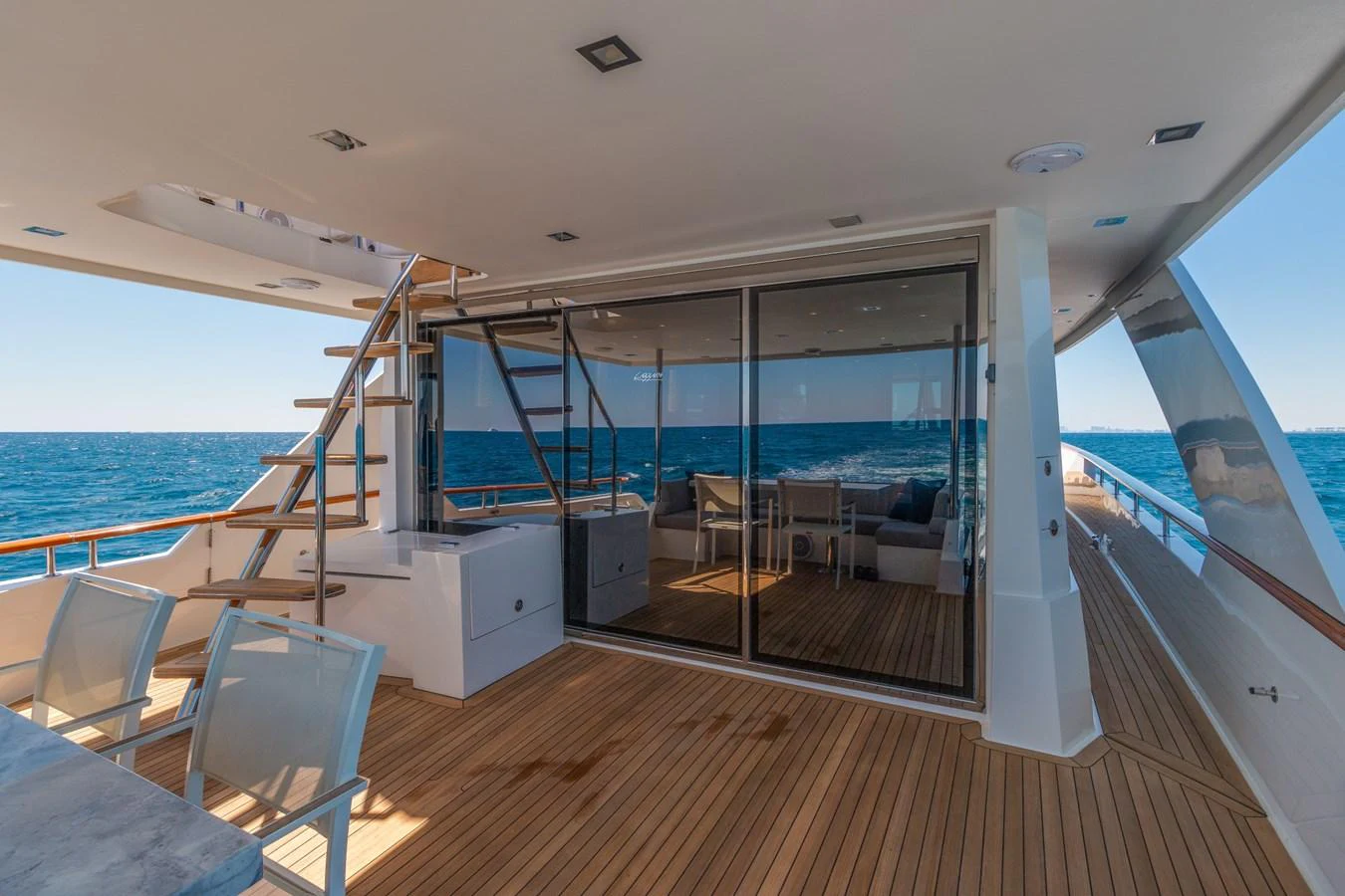 The aft deck offers a spacious and inviting area with comfortable seating and direct access to the interior. aboard WHISTLE Yacht for Sale