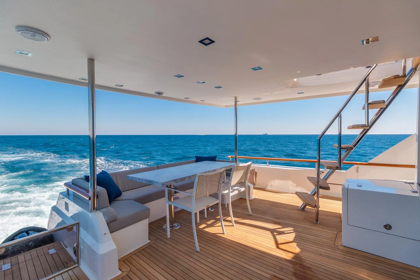 The aft deck offers a spacious and inviting area for alfresco dining with stunning ocean views. aboard WHISTLE Yacht for Sale