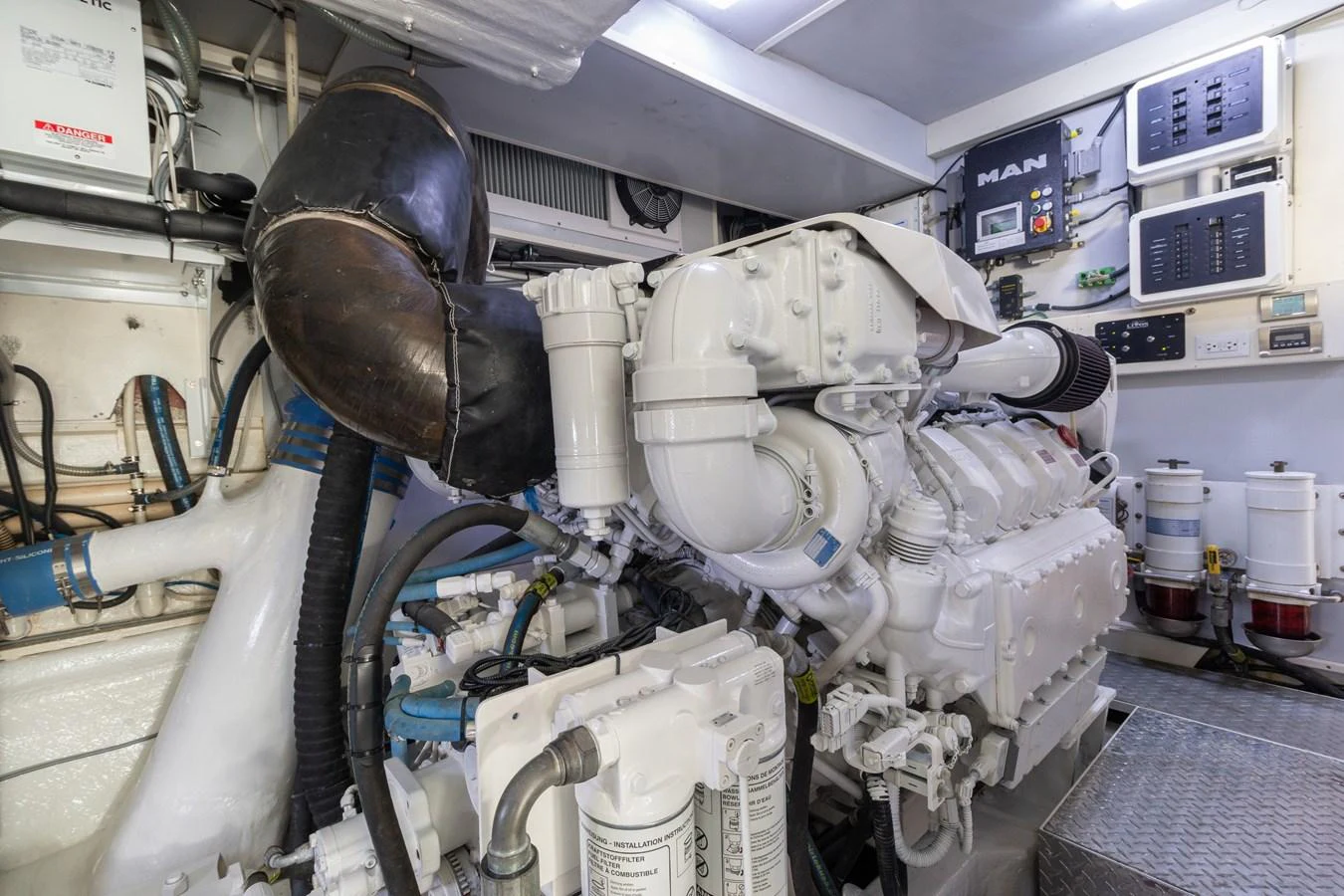 The image showcases the well-maintained engine room of the yacht, highlighting its powerful machinery and organized layout. aboard WHISTLE Yacht for Sale