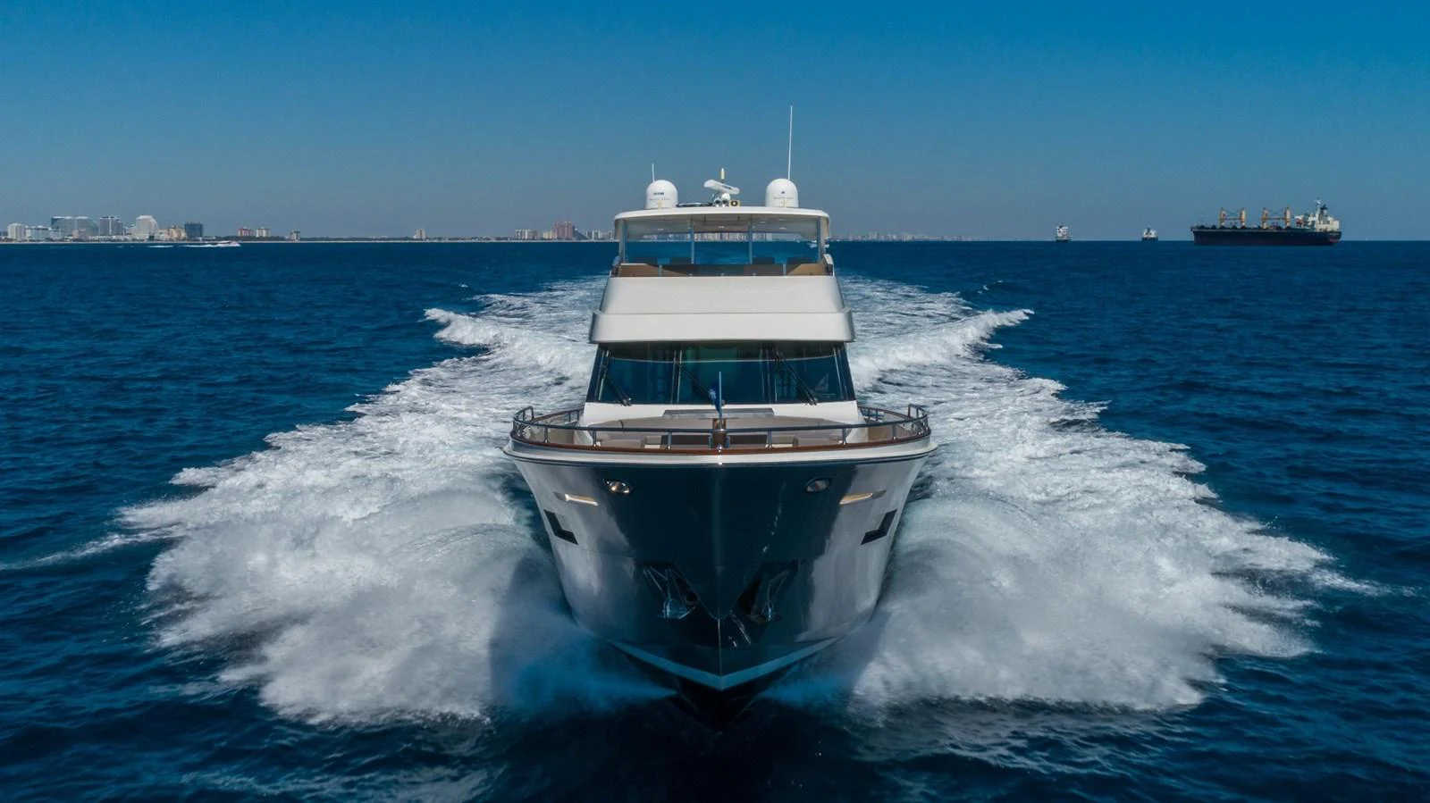 A sleek yacht cruises powerfully through the open water, leaving a trail of white wake behind. aboard WHISTLE Yacht for Sale