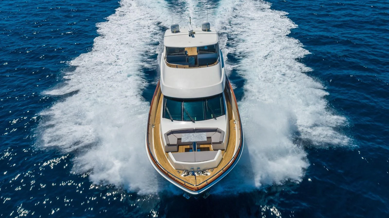 A luxurious yacht glides powerfully through the open sea, showcasing its sleek design and impressive performance. aboard WHISTLE Yacht for Sale