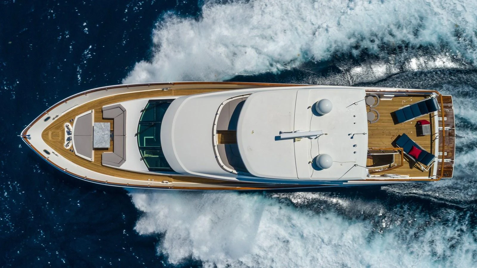 Aerial view of a luxurious yacht cruising through the water, showcasing its sleek design and spacious deck. aboard WHISTLE Yacht for Sale