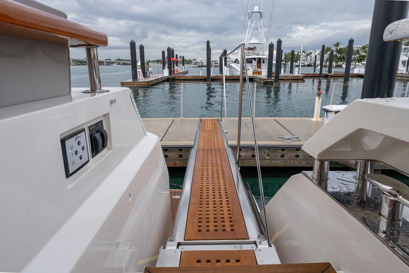The image showcases a sleek boarding platform extending from the yacht to the dock, highlighting the ease of access. aboard WHISTLE Yacht for Sale