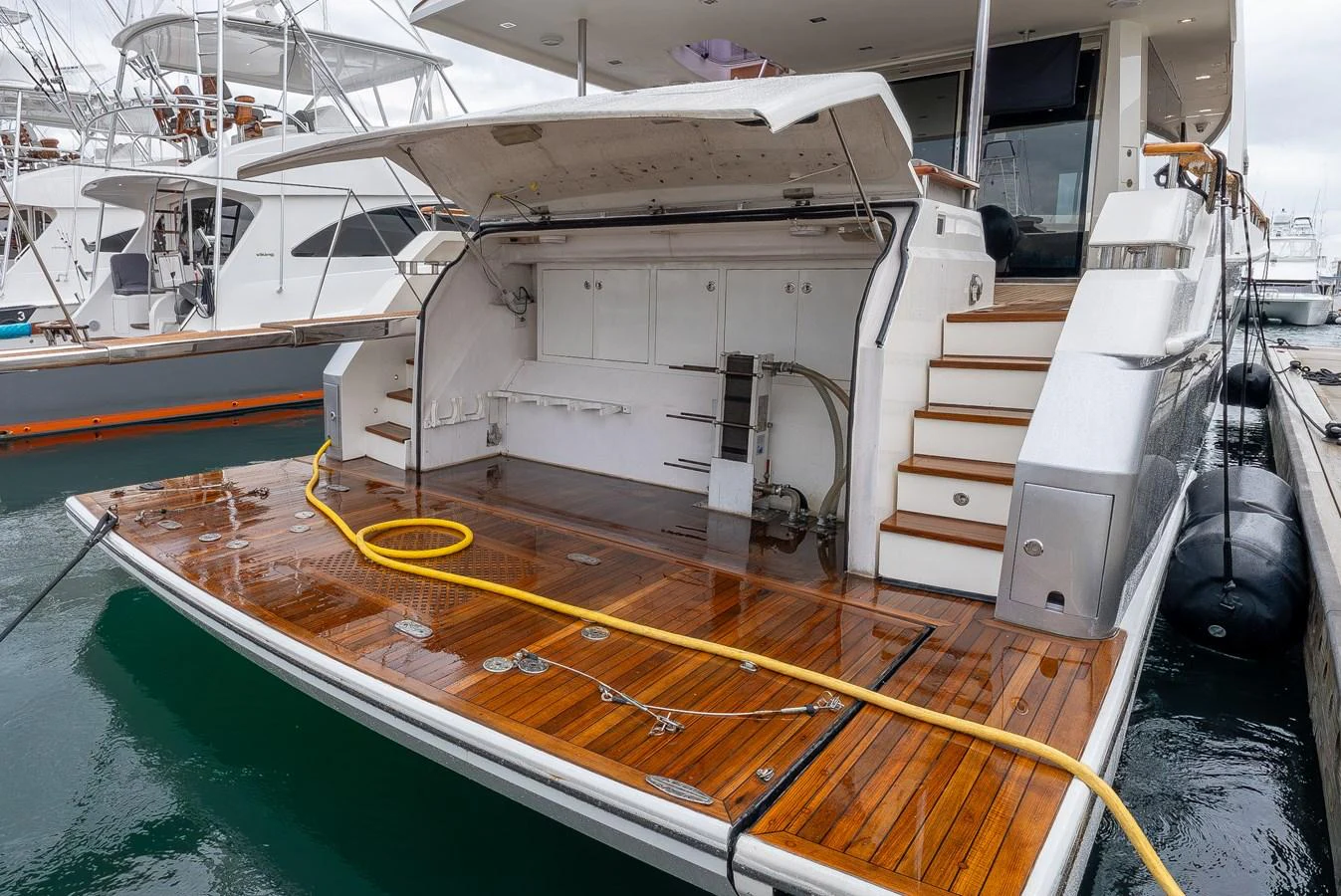 The yacht's aft deck features a spacious swim platform with teak flooring and convenient access to the water. aboard WHISTLE Yacht for Sale
