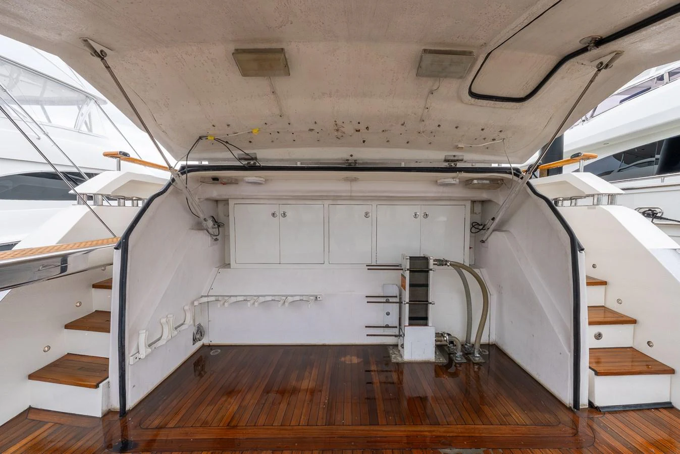 The image shows a yacht's storage area with various equipment and access to the deck. aboard WHISTLE Yacht for Sale