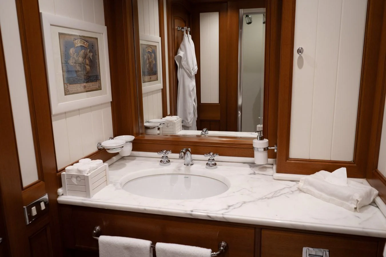 The yacht's bathroom features a luxurious marble countertop and elegant wooden accents. aboard HERITAGE M Yacht for Sale