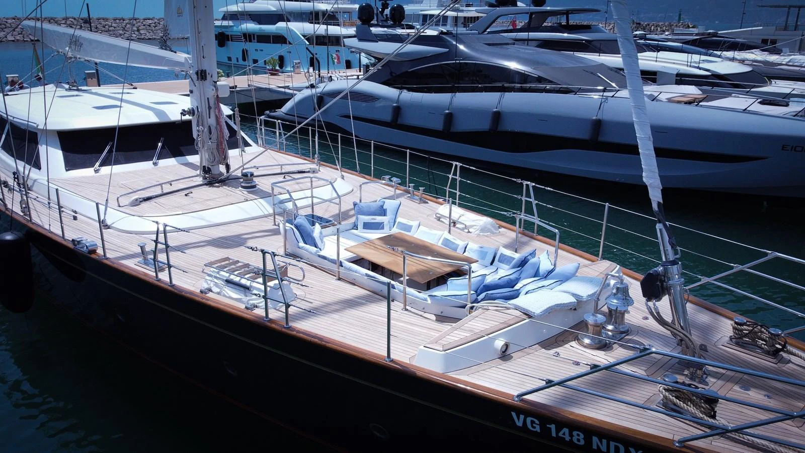 The yacht features a spacious and inviting deck area with comfortable seating and a central table, perfect for relaxation and socializing. aboard HERITAGE M Yacht for Sale