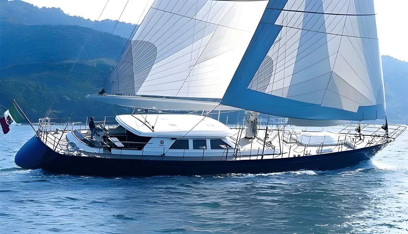 A sleek sailing yacht glides gracefully on the water with its sails fully deployed. aboard HERITAGE M Yacht for Sale