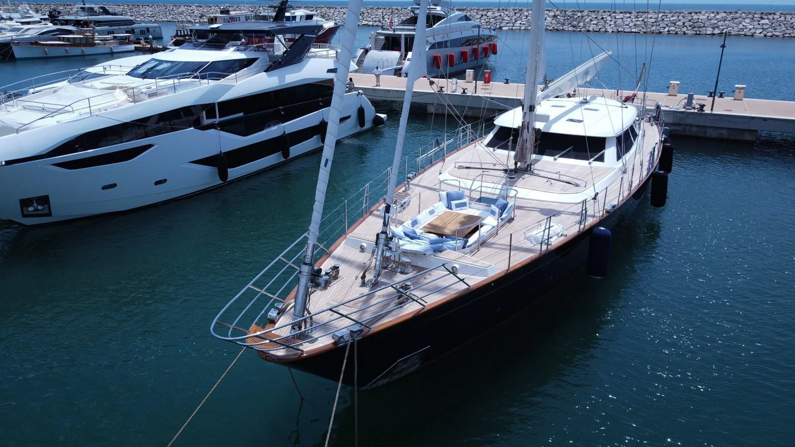 A sleek yacht is docked in a marina, showcasing its elegant design and spacious deck. aboard HERITAGE M Yacht for Sale