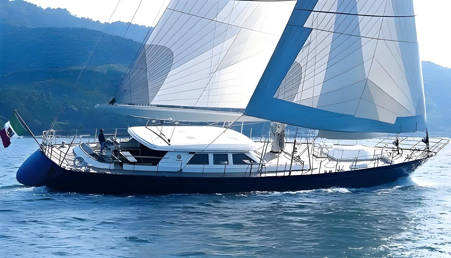 A sleek sailing yacht glides gracefully on calm waters with its sails fully unfurled. aboard HERITAGE M Yacht for Sale