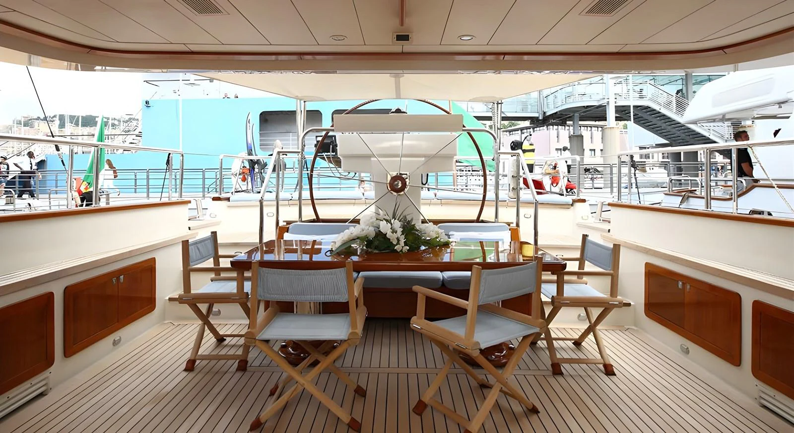 The aft deck features a stylish dining area with comfortable seating and elegant decor. aboard HERITAGE M Yacht for Sale