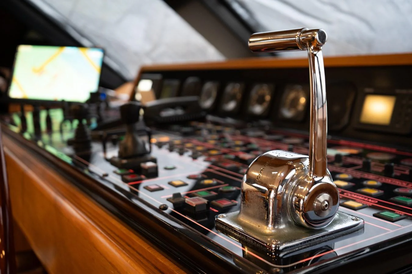 The helm station features a polished throttle lever and an array of navigational controls. aboard HERITAGE M Yacht for Sale