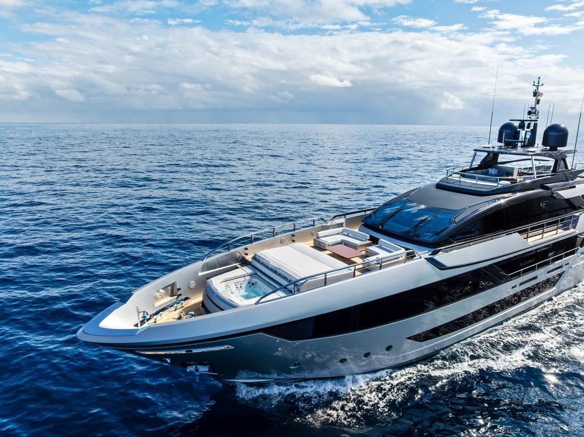 A sleek and modern yacht cruising on open waters under a partly cloudy sky. aboard EURO Yacht for Sale