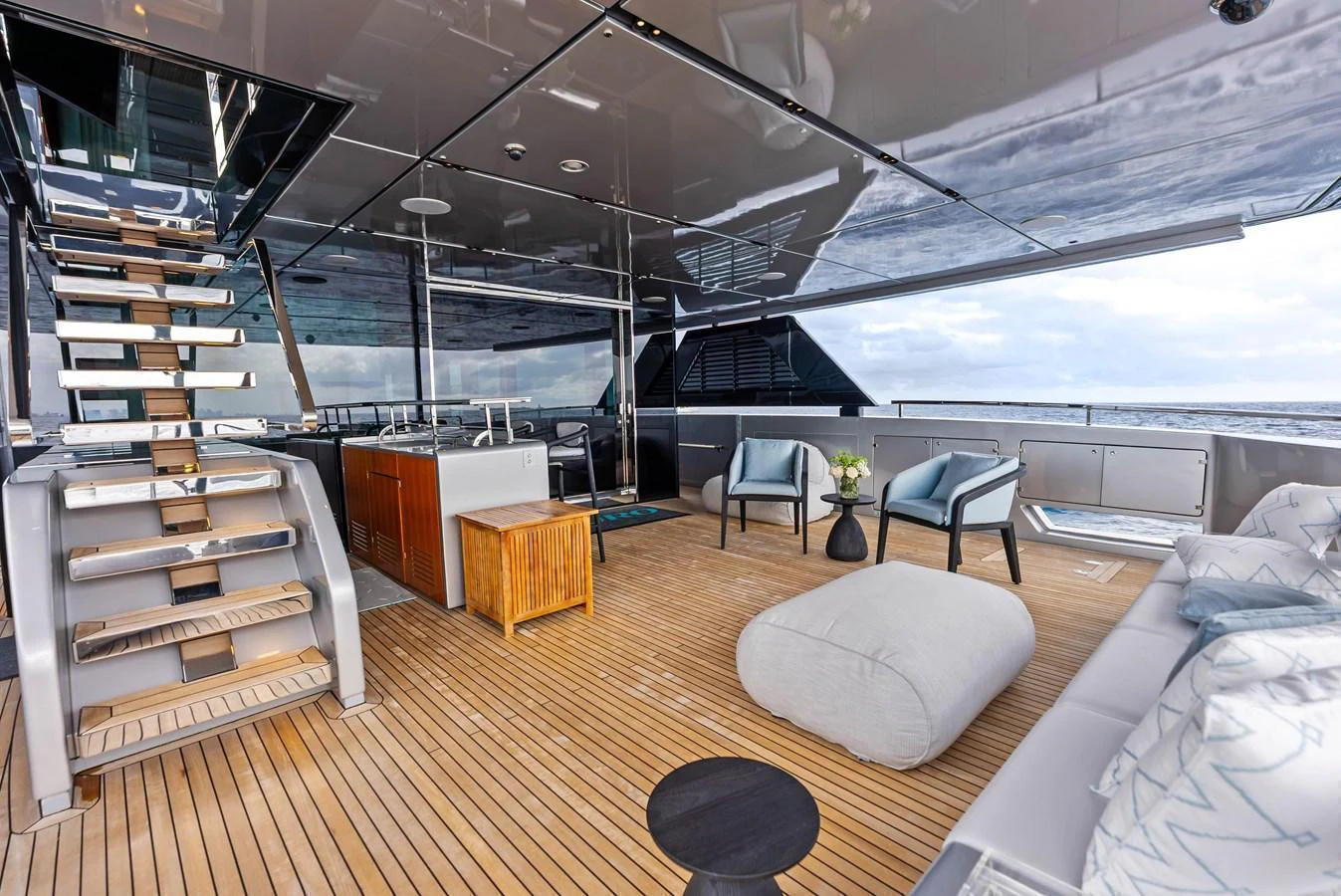 The aft deck features a stylish and spacious lounging area with modern furnishings and a beautiful ocean view. aboard EURO Yacht for Sale