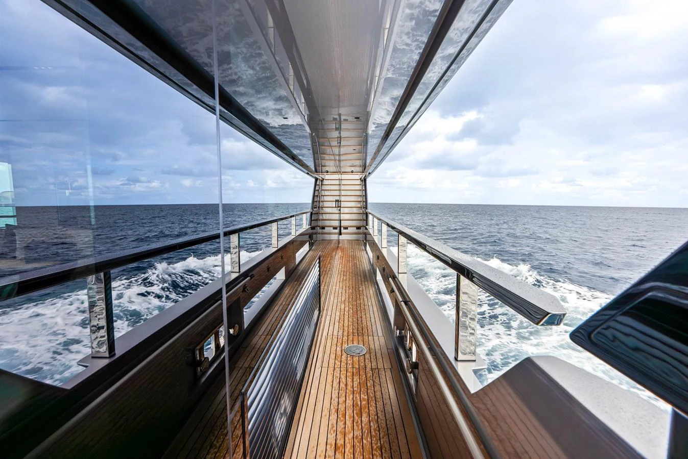 A sleek and modern exterior walkway with a view of the open sea. aboard EURO Yacht for Sale