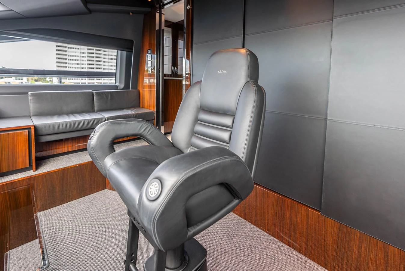 The helm area features a luxurious captain's chair with sleek, modern design elements. aboard EURO Yacht for Sale