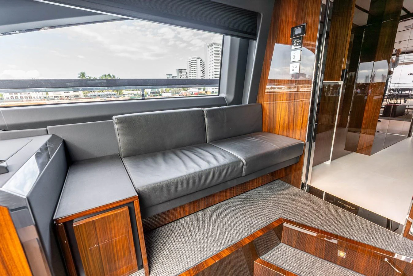 The yacht's interior features a sleek and modern seating area with large windows offering a view of the outside. aboard EURO Yacht for Sale