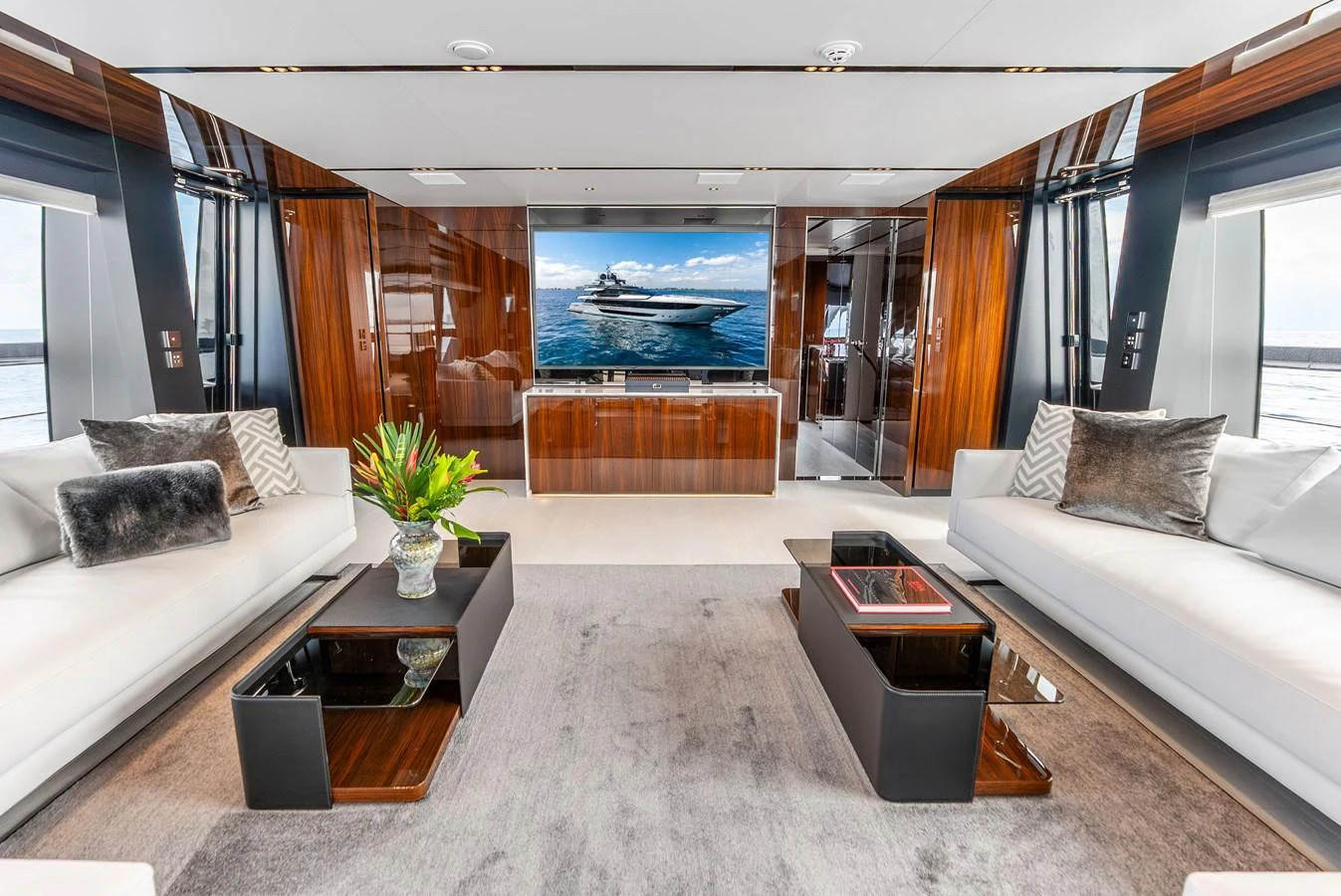 The salon features luxurious seating, modern decor, and a large TV for entertainment. aboard EURO Yacht for Sale
