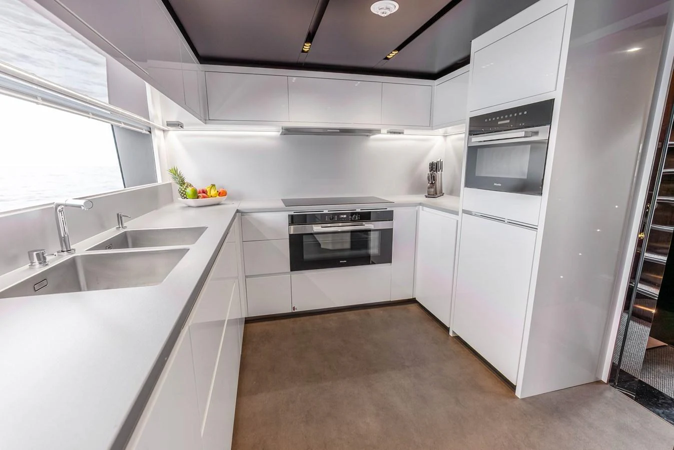 The modern galley features sleek white cabinetry, high-end appliances, and ample counter space. aboard EURO Yacht for Sale