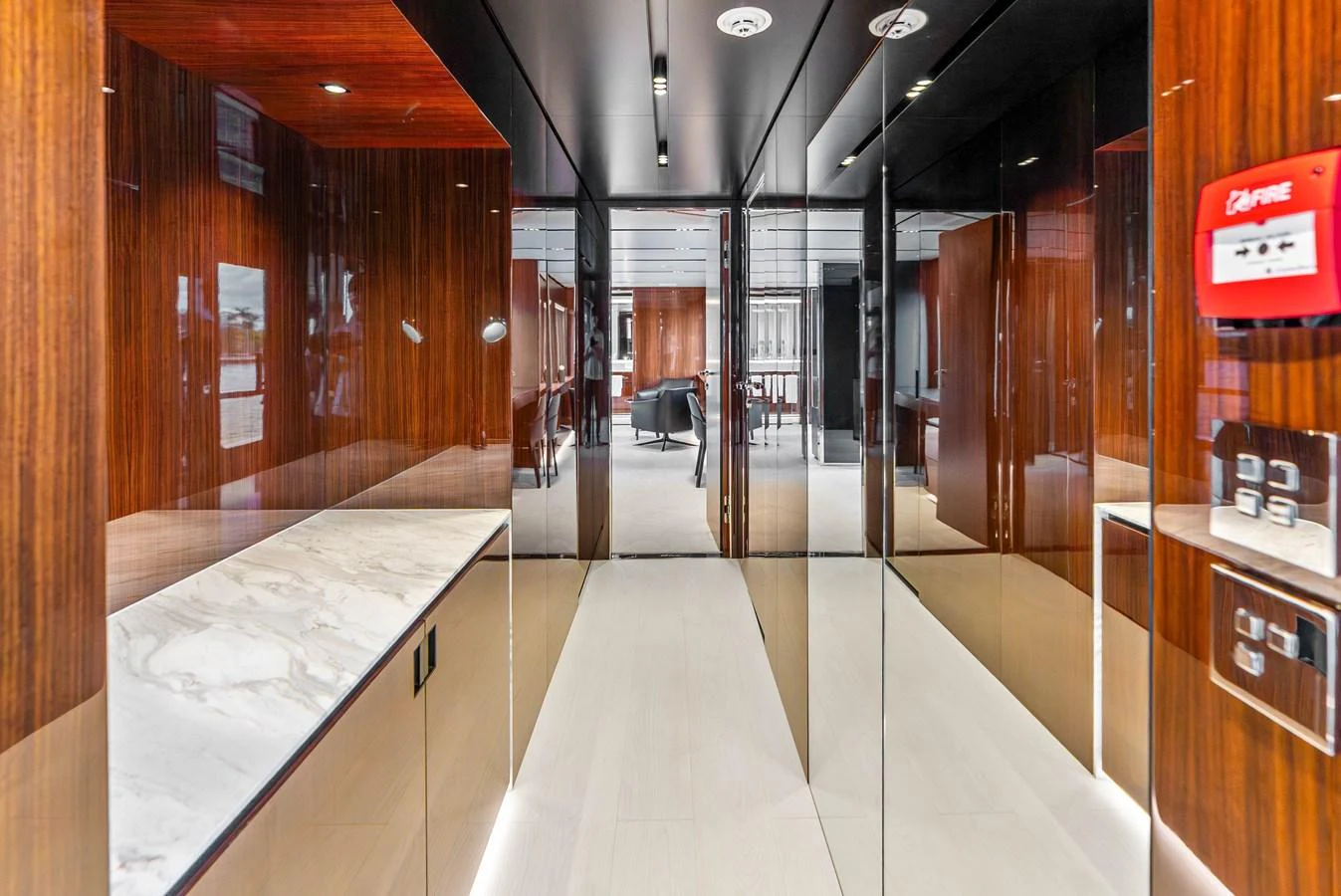 The image showcases a luxurious hallway with mirrored walls and a marble countertop. aboard EURO Yacht for Sale