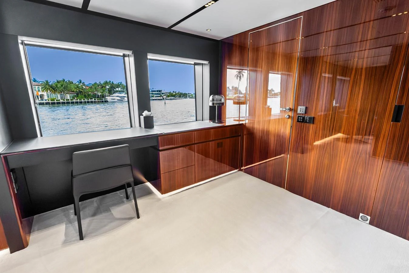 A sleek and modern interior space with large windows offering a view of the water. aboard EURO Yacht for Sale