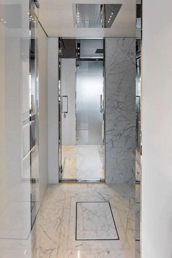 A luxurious yacht bathroom with marble flooring and walls, featuring modern fixtures and a sleek design. aboard EURO Yacht for Sale